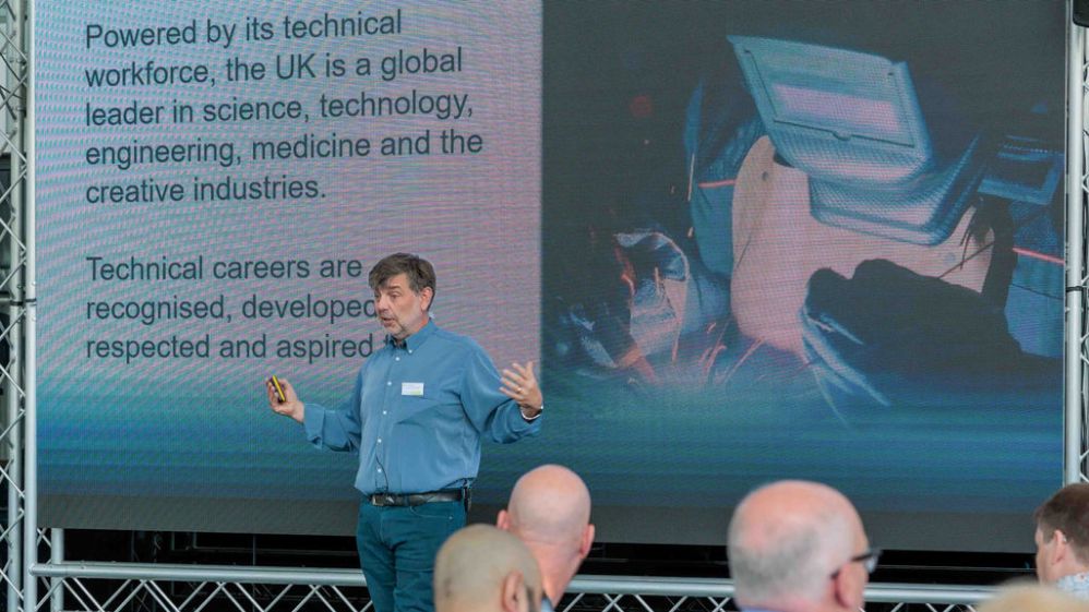 Dr Simon Breeden presents a slide with the words 'Powered by its technical workforce, the UK is a global leader in science, technology, engineering, medicine and the creative industries. Technical careers are recognised, developed, respected and aspired to.'