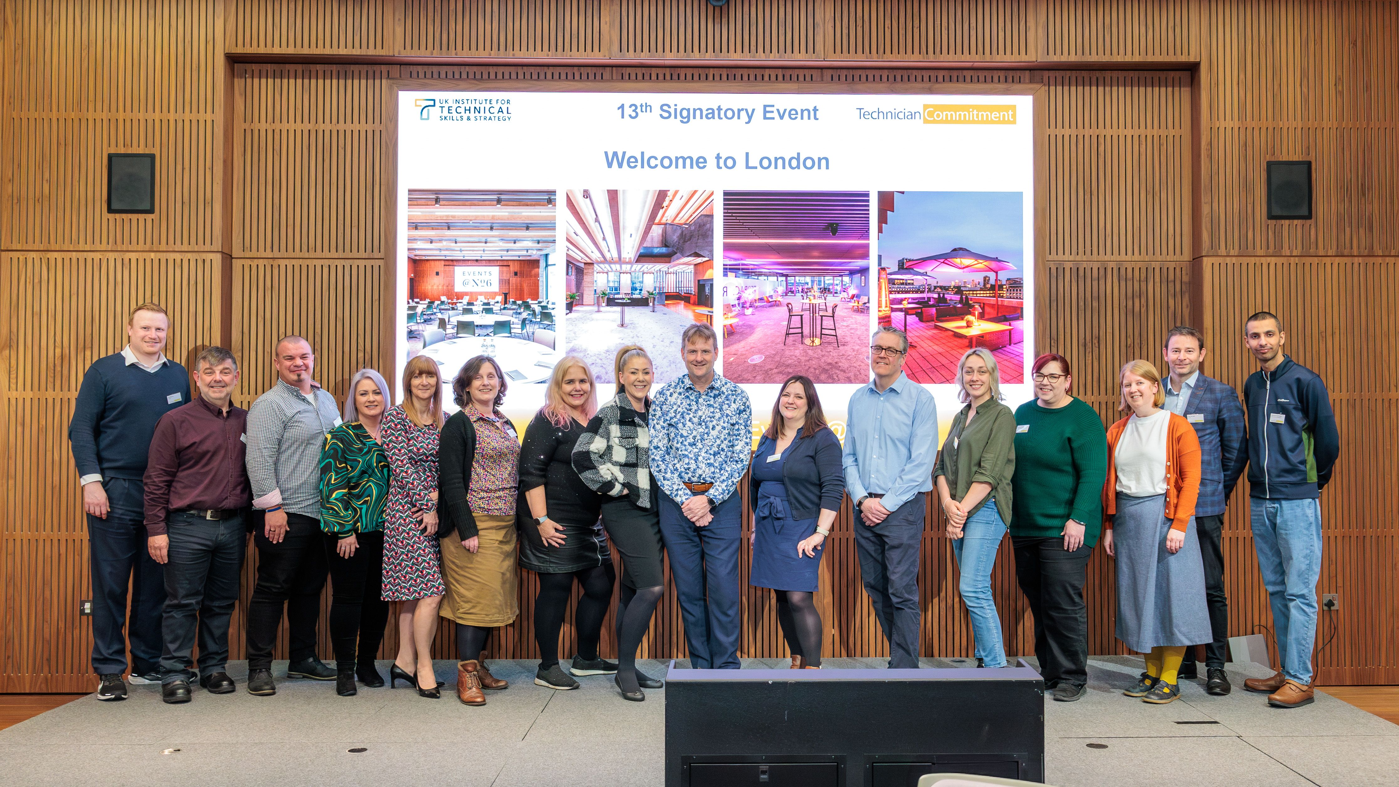 Speakers and presenters posed in front of a presentation screen reading '13th Signatory Event. Welcome to London'